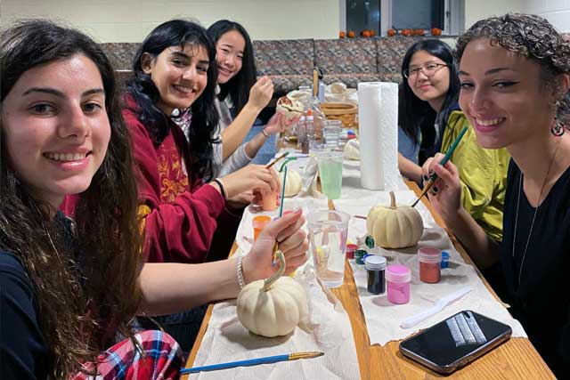 Student painting pumpkins.